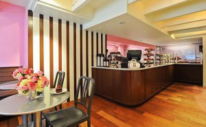 brightly colored cafe with tables, chairs, hardwood floors