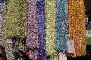 A selection of beautifully hand knitted colored scarves at the Blackberry Bear booth at the Fountain Hills art and craft show.