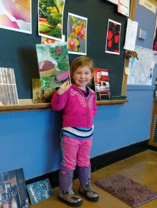 Child holding up her art design science project at the Rhinebeck Science Foundation Discovery Festival.