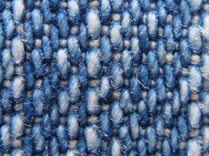 Close up image of denim fabric of blue jeans.