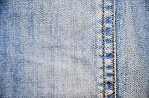 Close up of faded denim blue jeans.