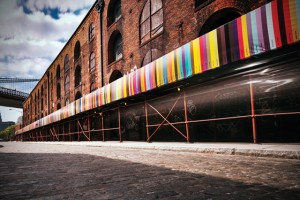 Chromapost building showing a wrapped around banner of various color swatches by Aleksandar Macasev