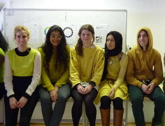 Spatial Design students wearing shades of yellow organize themselves based on hue, value and chroma.