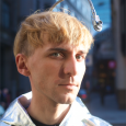 Neil Harbisson, color blind cyborg who hears colors, dressed in silver jacket.
