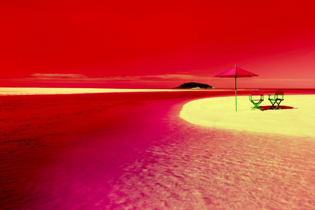 A beach scene with blue colors turned to red colors, based on Neil Harbisson, a color blind cyborg who hears colors, who says red sounds more relaxing than blue.