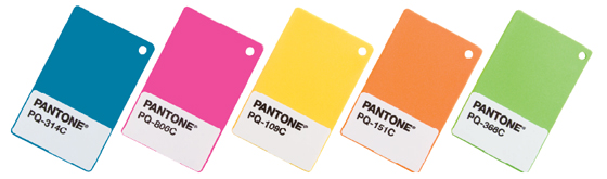 A row of Pantone plastic color standard chips in blue, pink, yellow, orange and green