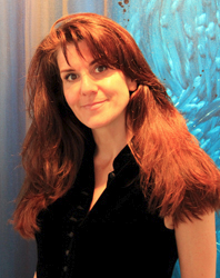 A headshot of artist Leanne Venier standing in front of one of her paintings