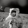 Apollo 12 astronaut Alan Bean on the moon with a lunar soil sample.