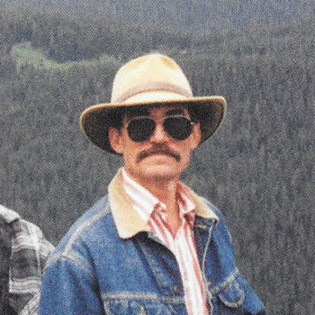 A photograph of soil scientist Lee A. Neve working in the fields of the Rocky Mountains