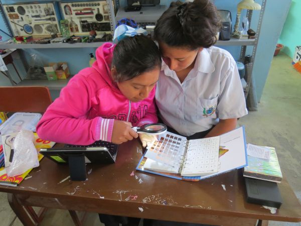 Students learning to use the Munsell Color Book to record data from ceramic sherds curated in the museum at their school, Maria Parado De Bellido in Nivín, Peru.