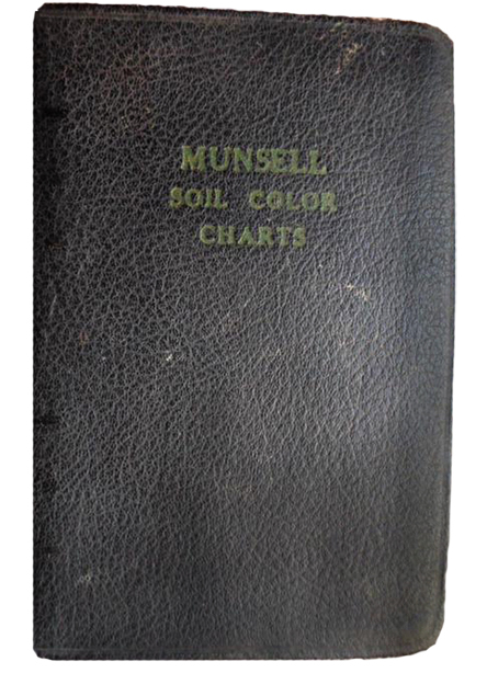 The 1954 1st edition Munsell Soil Book of Color in a dark paper cover