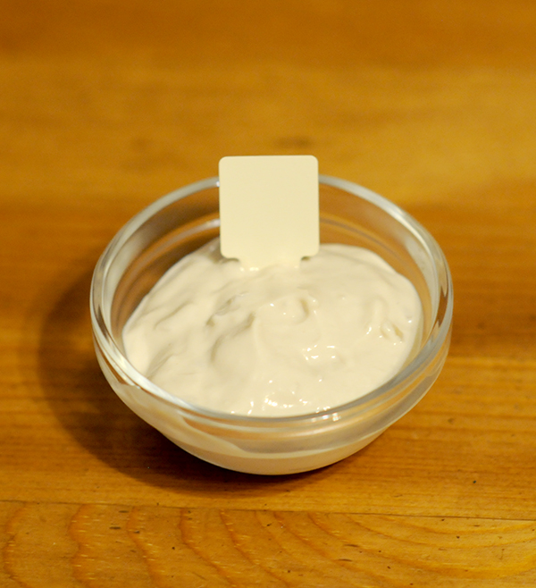 A glass jar filled with aoili sauce with the Munsell color notation