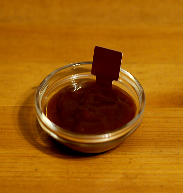 A glass jar filled with bbq sauce showing the Munsell color notation