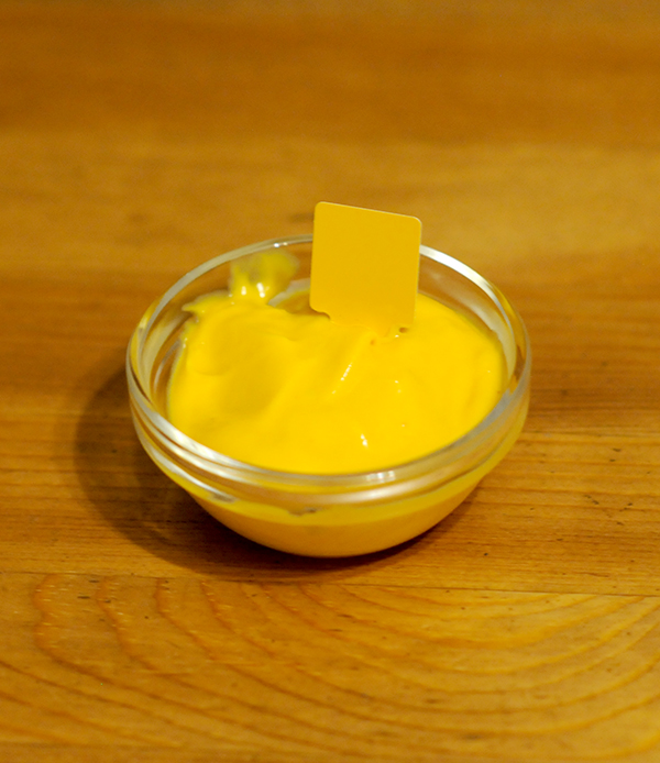 A glass jar filled with cheese showing a Munsell color notation