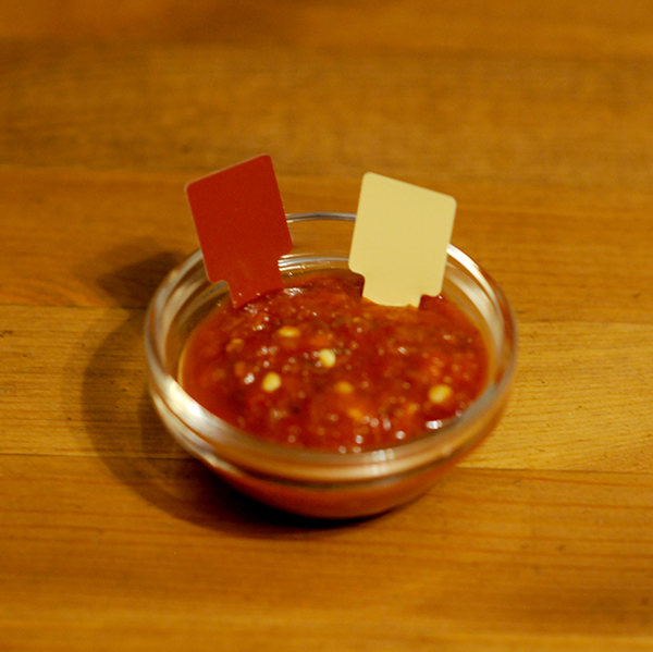 A glass jar filled with hot sauce showing Munsell color notation