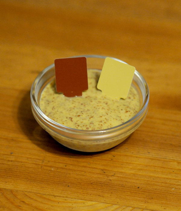 A glass jar filled with mustard showing the Munsell color notation