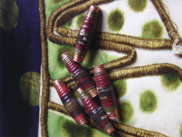 Red and green gold paper beads that mimics Ballet Russes