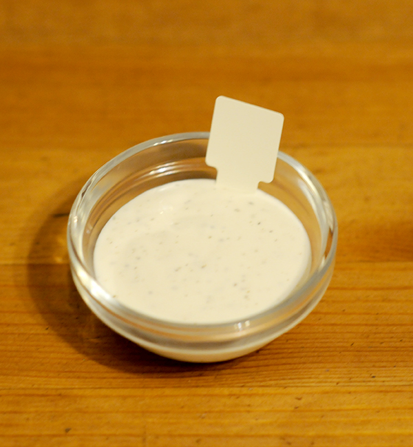 A glass jar filled with ranch dressing showing the Munsell color notation