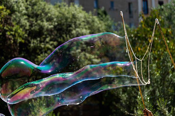A big bubble blown in a park shows the full color prism