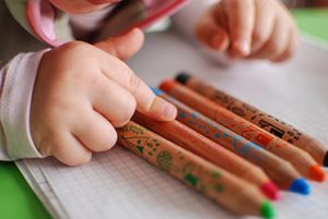 A first grader is learning about colors and picks out the red