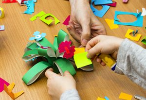 A fourth grader looks at various color hues when creating a flower in an art lesson