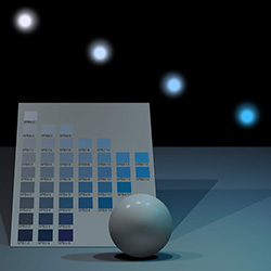 A ball with variations of light set in front of a Munsell color chart